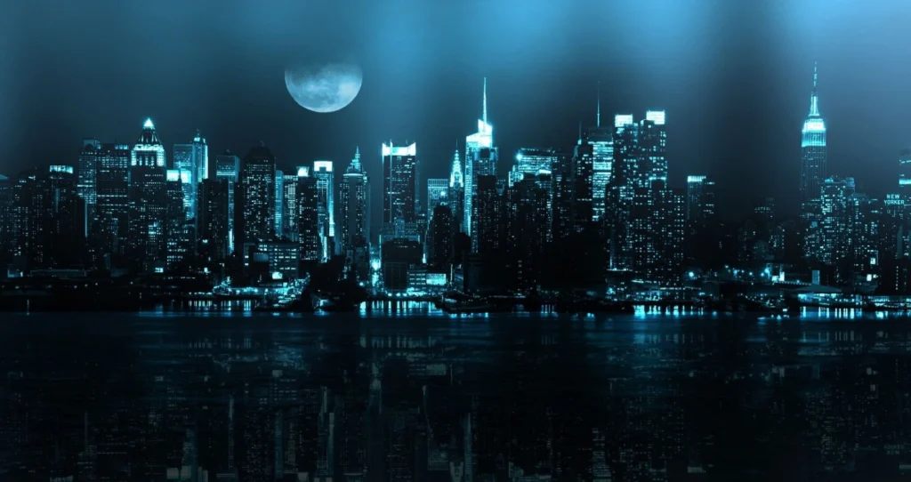 Picture of skyline in dark city at night and moon